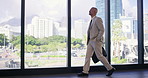 Office, building and businessman walking by window for professional, career and job in morning. Happy, attorney and travel with bag in lobby of law firm for corporate, work and start of legal case