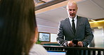 Business man, appointment schedule and reception at corporate consultation agency with secretary. Client, lobby and waiting room with phone at office admin counter and desk with check in for meeting
