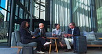 Business people, meeting and planning in lobby for collaboration, diversity and discussion with suitcase. Corporate, travel and waiting room conversation for networking, clients and industry contact