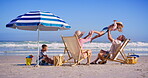 Family, relax and children at ocean with airplane, bonding and happiness on summer vacation. Parents, kids and fly fantasy at beach umbrella for love, support or appreciation for travel to California