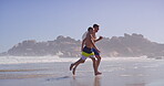 Father, son and running on beach for tropical summer holiday, bonding and relax together. Child, dad and race on ocean vacation with smile, waves and fun island adventure on happy weekend morning
