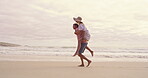 Piggyback, romance and walking with couple on beach together for honeymoon holiday, travel or vacation. Anniversary, carry or playful with happy man and woman in nature for adventure or bonding