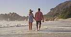 Holding hands, love and walking with couple on beach together for holiday, travel or vacation. Back, relationship or romance with man and woman on sand by ocean or sea of tropical island paradise