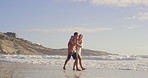 Holding hands, walking and wind with couple on beach together for holiday, travel or vacation. Laughing, love or romance with funny man and woman on sand by ocean or sea of tropical island paradise
