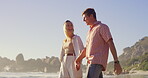 Conversation, holding hands and walking with couple on beach together for holiday, travel or vacation. Love, laughing or romance with man and woman on sand by ocean or sea of tropical island paradise