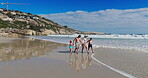 Family, play and holding hands with walking on beach for summer vacation, tropical journey and bonding together. Parents, children and ocean water with holiday game, calm morning and travel adventure