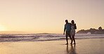 Beach, hug and couple on holiday, talking and bonding in nature, conversation and romance on date. Love, man and happy with woman, travel and peace of ocean, relax and getaway for lovers and sunset