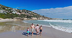 Parents, children and holding hands with walking on beach for summer vacation, tropical journey and bonding together. Family, kids and ocean water with holiday fun, calm morning and travel adventure