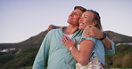 Couple, happy and outdoor with hug for travel, journey and commitment on summer vacation. Mature man, woman and love in nature for anniversary, milestone holiday and healthy marriage in California