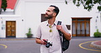 Happy, man and walking with camera for holiday, travel and photography on journey in London neighborhood. Thinking, backpack and outdoor on town street with bag for trip and weekend in morning
