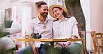 Love, date and camera with couple in cafe for travel vlog, streaming and social media. Laughing, happiness and summer vacation with man and woman in outdoor coffee shop for romance and photography