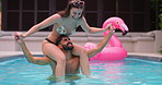 Balance, pool party and couple shoulder carry with fun, splash and bonding at hotel or resort. Swimming, love and man with woman, water and laughing for summer event, holiday celebration or adventure