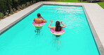 Inflatable, swimming or couple in pool for vacation, bonding or weekend in summer together. House backyard, back or people speaking of floaters for outdoor travel, hotel or honeymoon in Australia