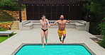 Travel, couple and jumping in pool on holiday for summer adventure, recreation and bonding together at resort. Swimming, people and holding hands with water splash for freedom at vacation destination