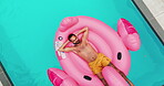 Aerial, man and floating in swimming pool outdoor for summer vacation, luxury resort and hospitality trip. Drone, male person and rest for inflatable flamingo, water and holiday destination at lodge 