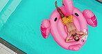 Drone, man and floating in swimming pool outdoor for summer vacation, luxury resort and hospitality trip. Aerial, male person and rest for inflatable flamingo, water and holiday destination at lodge 