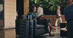 Business, headphones and tablet with black woman in airport lobby for planning, research or travel. Chair, music and streaming with happy flight passenger in terminal for design or web development