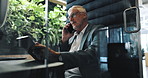 Business, phone call and tablet with man in office for communication, planning or research. Communication, corporate and thinking with mature employee in pod at workplace for mobile conversation