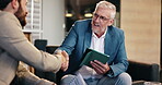 Handshake, meeting and tablet with business people in lobby of office for agreement or discussion. Chair, collaboration and conversation with employee people shaking hands at work for deal or success