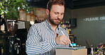 Happy, entrepreneur and man with tablet, online order and checklist for stock with stylus and coffee shop. Small business, inventory and preparing for delivery with tech, cafe and person with boxes