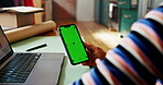 Phone, green screen and hand at laptop for small business, connectivity or mockup space. Entrepreneur, person or tech at desk for startup management, online review or web update with tracking markers