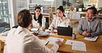 Collaboration, meeting and proposal with business people in boardroom of office together for strategy. Documents, laptop and review with employee team in workplace for seminar, training or workshop