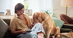 Woman, dog and relax on sofa with treats, feeding and phone for pet training tips in home. Girl, support animal or Labrador in living room with obedience lesson, reward or happy for trust development