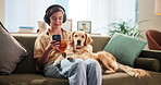 Home, dog or woman with mobile for music, podcast or bonding with domestic pet on sofa. House, animal or golden retriever with female person for phone, audio track or headphones for listening to song