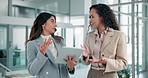 Women, tablet and discussion in hallway at office, planning and review stats with advice at insurance company. People, partner and results for risk management survey with app for feedback at agency