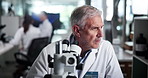 Scientist, man and microscope at laboratory with research, test and review for sample in pharmaceutical study. Person, process and clinical trial for medicine, perspective and solution for results