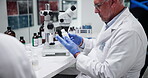 Label, pharmacist and man with medicine, lab and info for treatment of disease, healthcare and science. Pharmaceutical, medical professional and mature person with container, serious and antibiotics