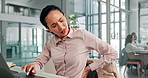 Back pain, burnout and laptop with business woman in office for deadline or discomfort. Computer, injury or spine and employee person at desk in workplace with muscle cramp, inflammation or strain