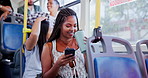 Bus, student and woman with phone and drink in city for journey, commute and travel to college and university. Public transport, happy and person on smartphone for social media, internet and website