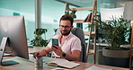 Business, man and computer with smartphone in office for mobile notification, checking text message and happy. Corporate finance manager, person or smile with phone at desk for email and multitasking
