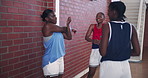 Sports, basketball player and stretching women, team and happy with fist bump for greeting. African girls, exercise and friends training at university for preparation, warm up or talking for fitness