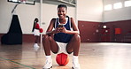 Basketball, sport and happy player with phone on court for training break, funny chat or laughing for text message. Fitness, girl and relax on ball for social media meme, workout joke or notification