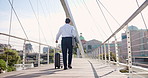Suitcase, travel and back of businessman on bridge in city for global journey for finance career. Luggage, walking and professional male financial executive with baggage for work trip outdoor in town