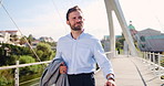 Suitcase, happy and businessman on bridge in city for global journey for finance career. Luggage, walking and professional male financial executive with baggage for work trip outdoor in urban town.