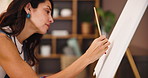 Woman, painter and brush with canvas in home with creativity, process and color with project in studio. Person, artist and stroke with painting, drawing and craft with profile in lounge at apartment