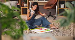 Woman, artist and painting with brush on floor for creative development or design at home. Female person, freelance designer or painter with canvas for creativity or artistic expression at house