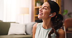 Phone, earphones and woman in home with music, playlist or album online for relax, calm and zen. Happy, dance and person streaming radio on mobile app with audio tech in living room at apartment.