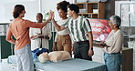 first aid, happy and people high five for success, presentation or skill development with mannequin. Group, dummy or paramedic clapping for medical achievement, healthcare training or course goal