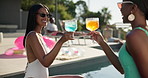 Women, friends and cheers with drink at pool for summer holiday, vacation or weekend at party. Female people, toast or cocktail with sunglasses or smile for good vibes or fun time at luxury resort
