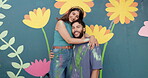Face, smile and couple hug for painting of mural wall, creativity and decoration of community project. Portrait, man and woman embrace with art hobby, flower aesthetic and bonding for diy inspiration