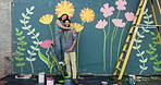 Face, couple and hug with painting on wall for mural art, creativity and decoration of community project. Portrait, man and woman embracing for hobby, flower aesthetic and bonding for diy inspiration