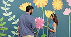 Couple, painting and support with wall art for mural design, creativity and decoration of community project. Man, woman and help as artist with hobby, flower aesthetic and bonding for diy inspiration