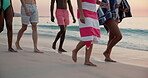 Beach, group and feet with walking on vacation, holiday weekend and laughing by sunset in summer. Ocean, legs and people with travel for social gathering, reunion and friends with bonding in closeup