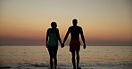 Holding hands, silhouette or couple at beach walking for vacation, anniversary or honeymoon holiday. Paradise, sunset or romantic people bonding at sea together for travel, relationship or ocean trip