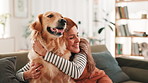 Hug, sofa and woman with dog in home for bonding, relaxing and playing together in living room. Pet owner, best friend and happy person with Golden Retriever on couch for affection, petting and love