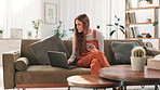 Girl, phone and laptop on sofa in home with online shopping, click and banking with easy payment. Woman, smartphone and computer with smile for deal, sale and mobile app for fintech with ecommerce
